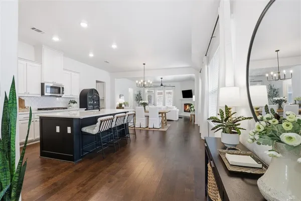 a kitchen with stainless steel appliances kitchen island granite countertop a stove a sink and a refrigerator