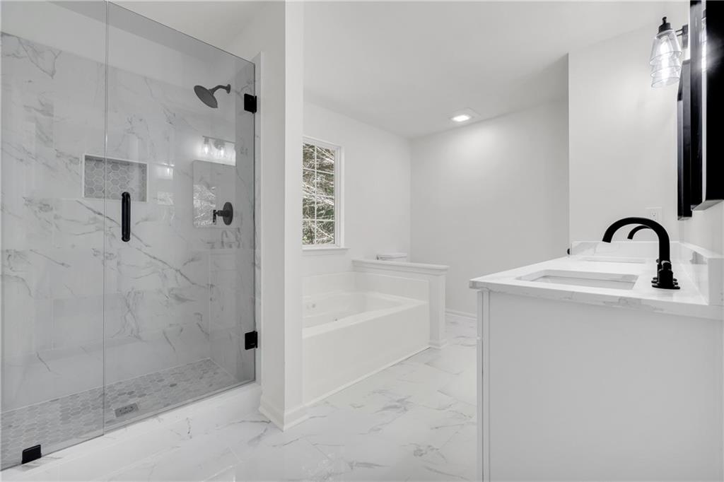 2941 Lake Hollow Road Gainesville, GA 30501 - Photo 28 of 53 a bathroom with a sink a shower and mirror