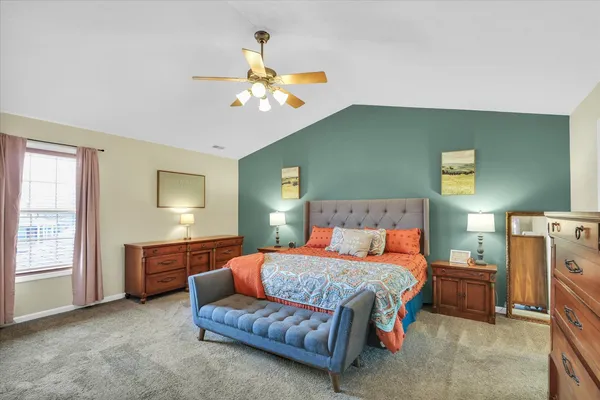 a bedroom with a large bed and a tv