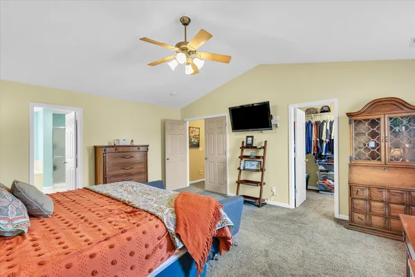 a bathroom with a tub a double vanity sink and a large mirror