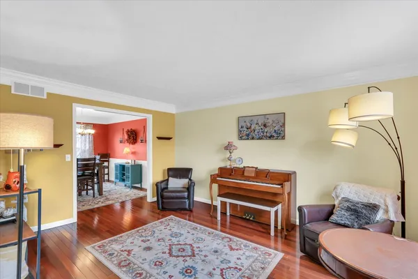 a living room with furniture a rug and a lamp