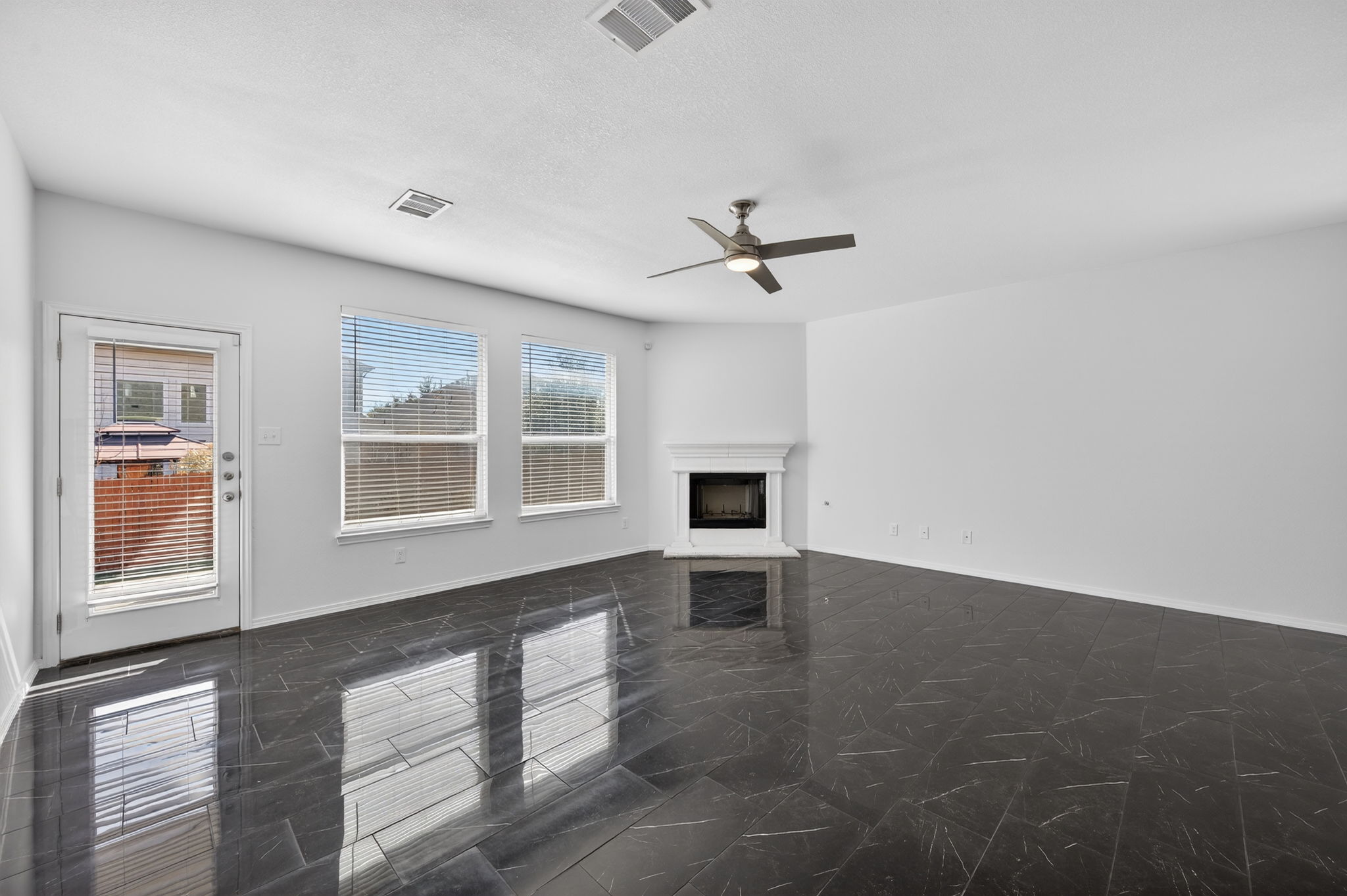 2305 Gavin Trail Pflugerville, TX 78660 - Photo 12 of 40 a view of an empty room with a window and wooden floor