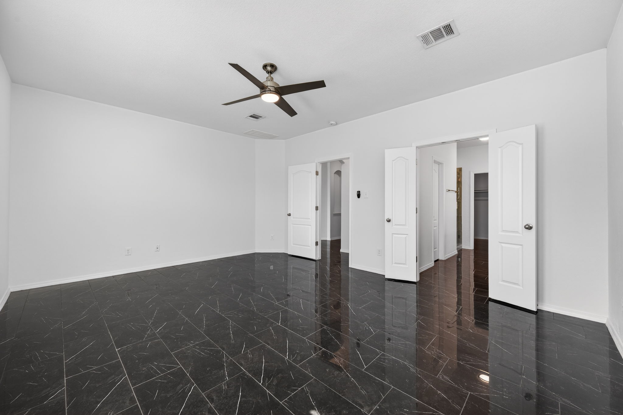 2305 Gavin Trail Pflugerville, TX 78660 - Photo 17 of 40 a view of empty room with wooden floor and ceiling fan