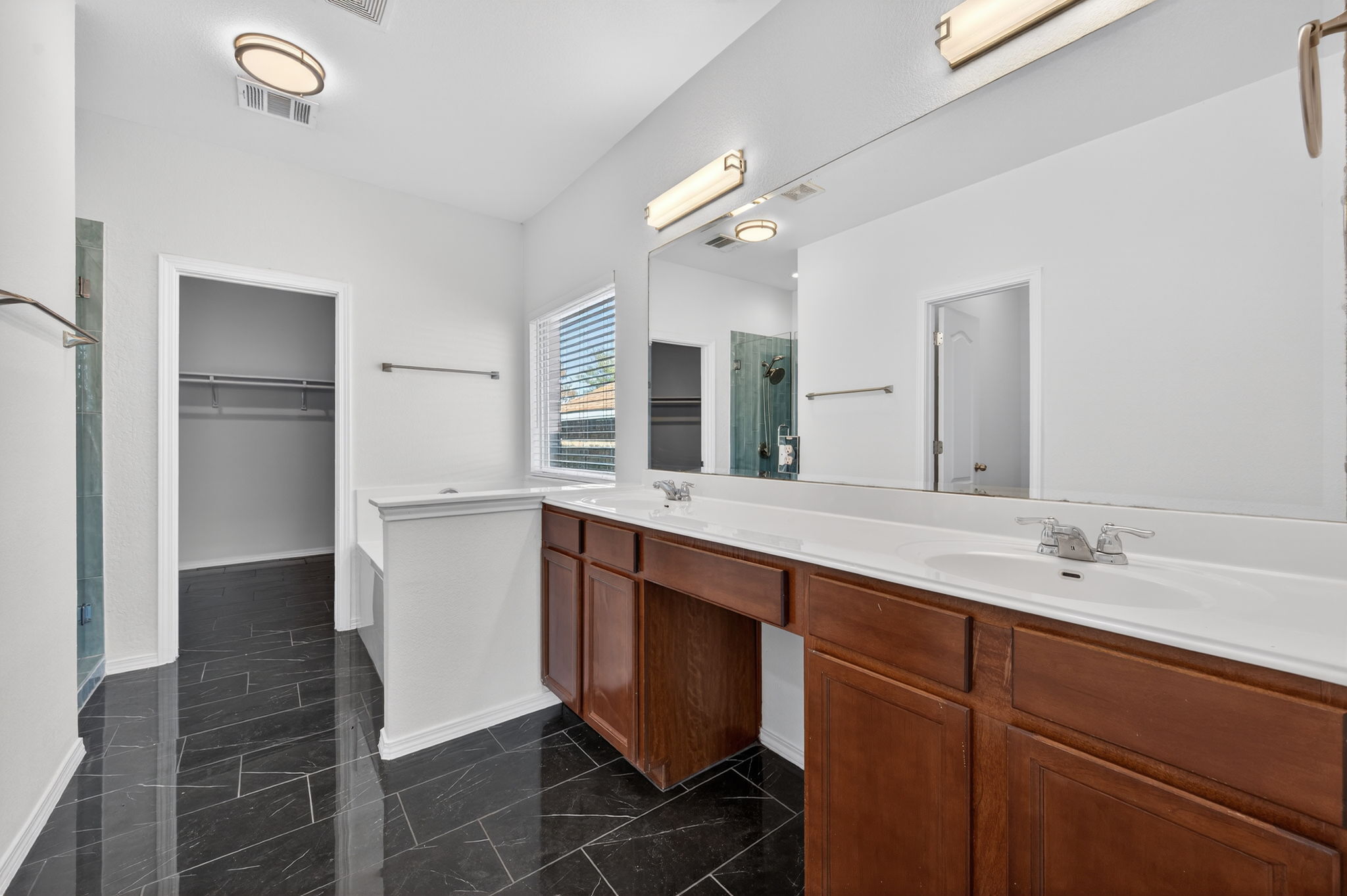 2305 Gavin Trail Pflugerville, TX 78660 - Photo 18 of 40 a spacious bathroom with a double vanity sink a mirror and a shower