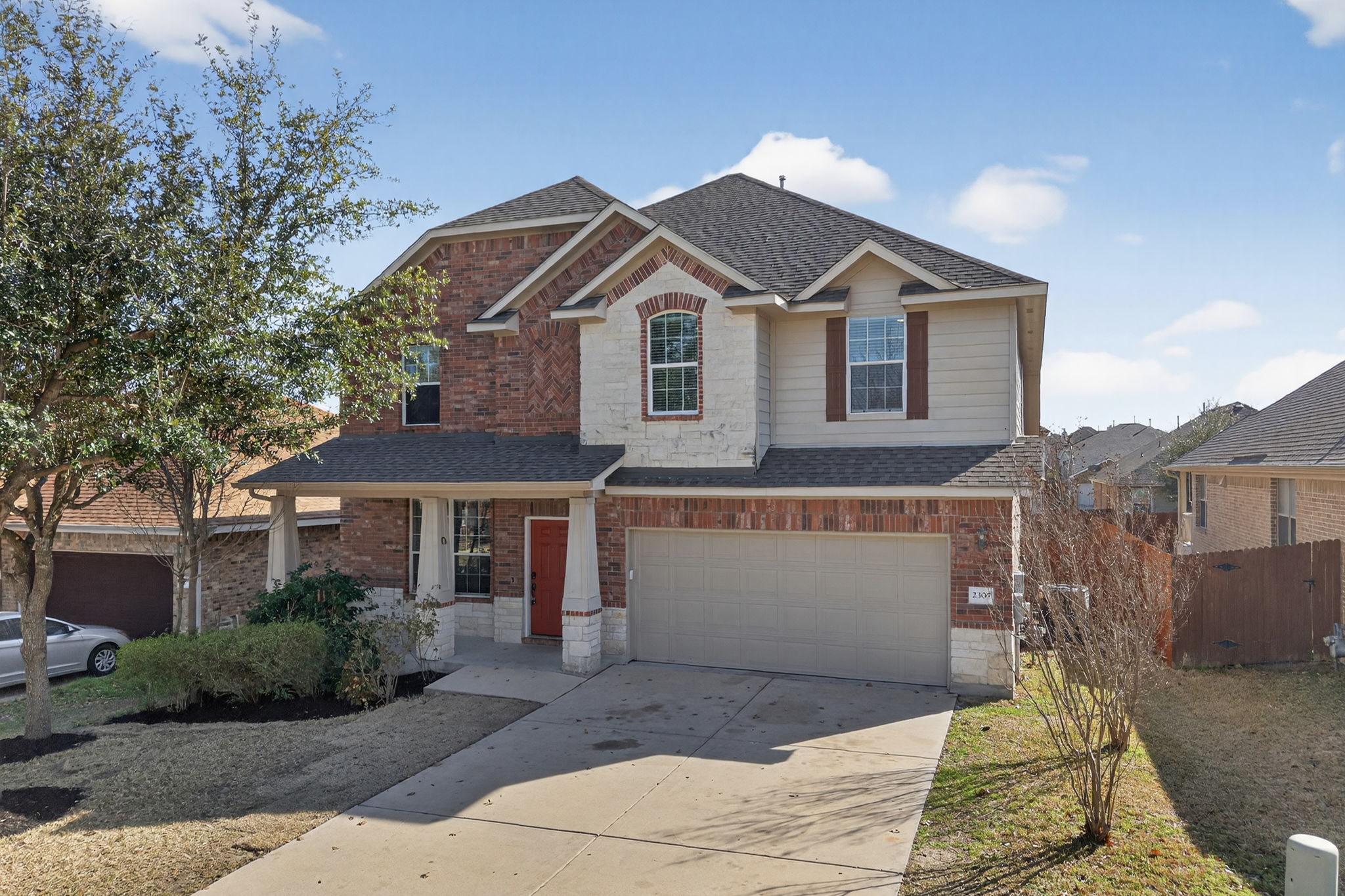 2305 Gavin Trail Pflugerville, TX 78660 - Photo 2 of 40 a front view of a house with a yard and garage