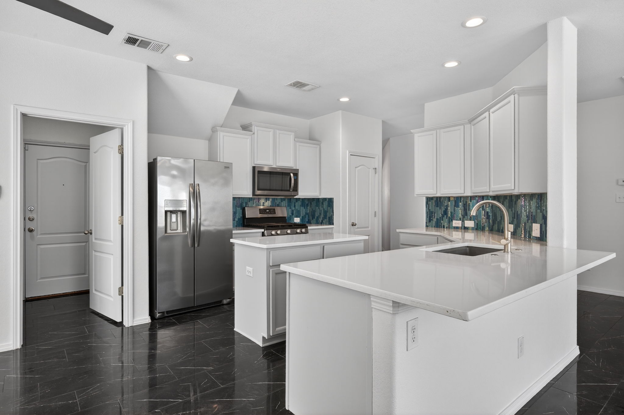 2305 Gavin Trail Pflugerville, TX 78660 - Photo 7 of 40 a kitchen with a refrigerator a stove top oven a sink and cabinets