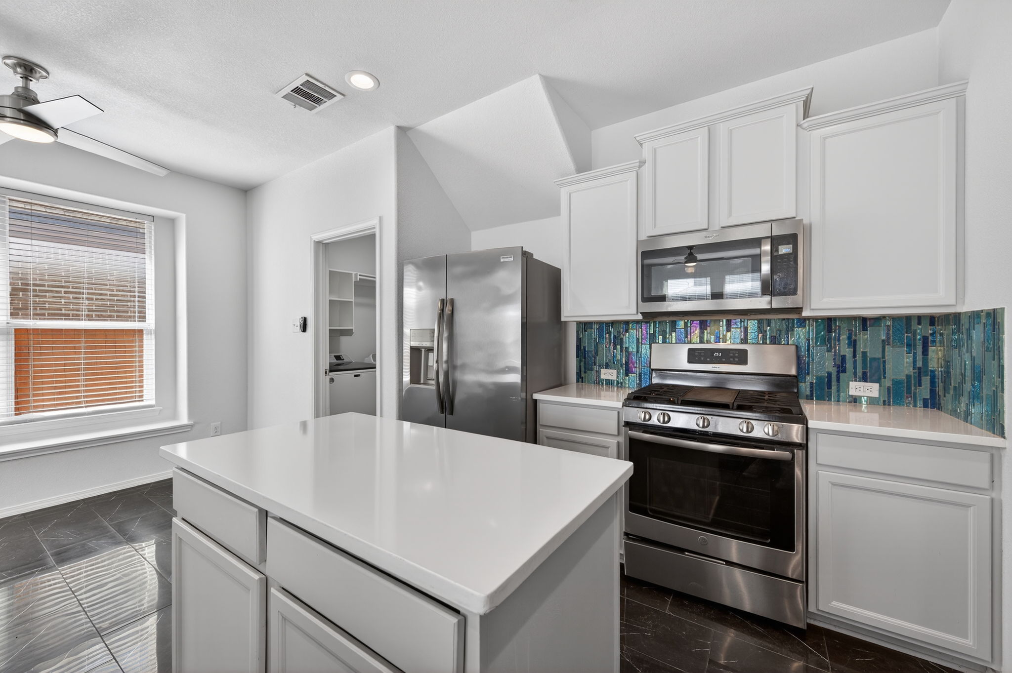 2305 Gavin Trail Pflugerville, TX 78660 - Photo 8 of 40 a kitchen with a stove and a refrigerator