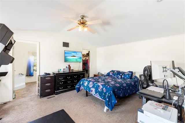 a bed room with a bed and a television