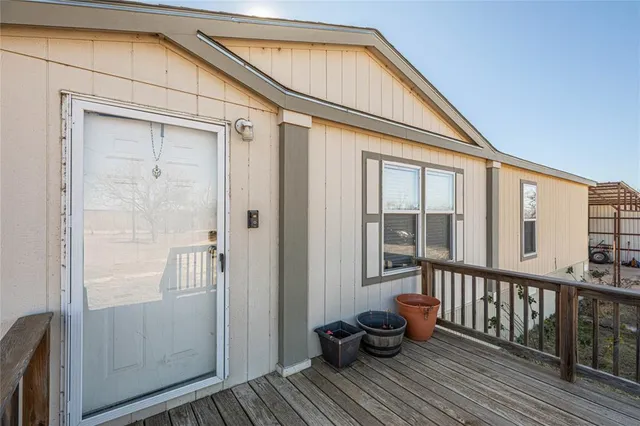 a view of a balcony with chair and wooden floor
