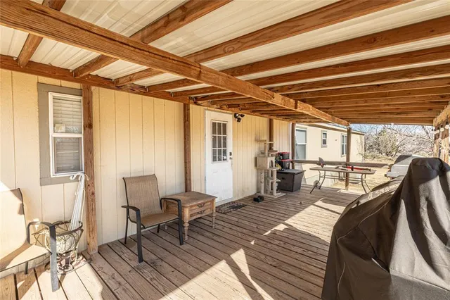 a dining room with wooden floor and furniture