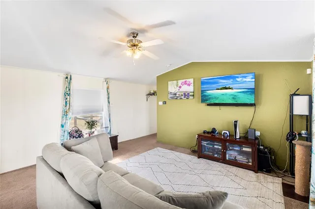 a living room with furniture and painting on the wall