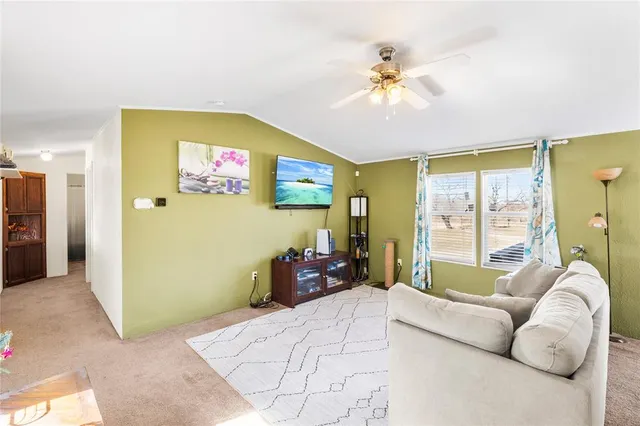 a spacious bedroom with a large bed and a chandelier