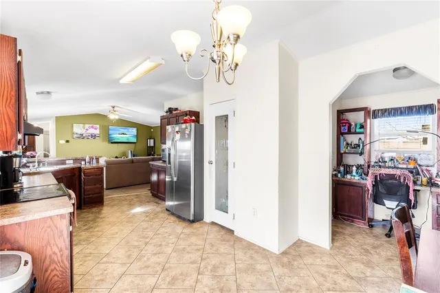 a living room with furniture a chandelier and a dining table