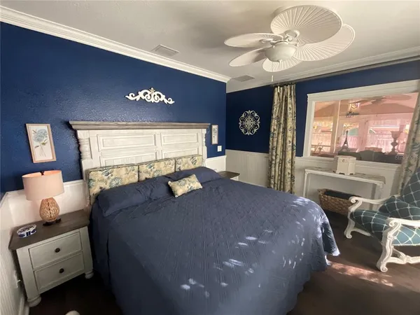 a bed room with a bed and a large window