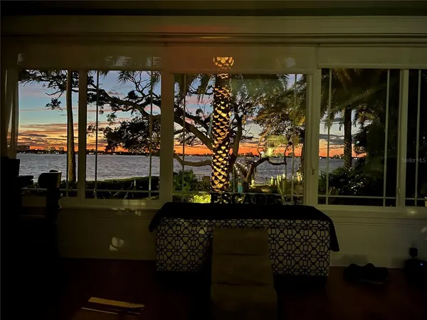 a view of a porch with a chair and potted plants