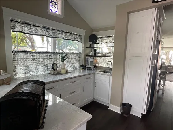 a kitchen with a sink a refrigerator and window