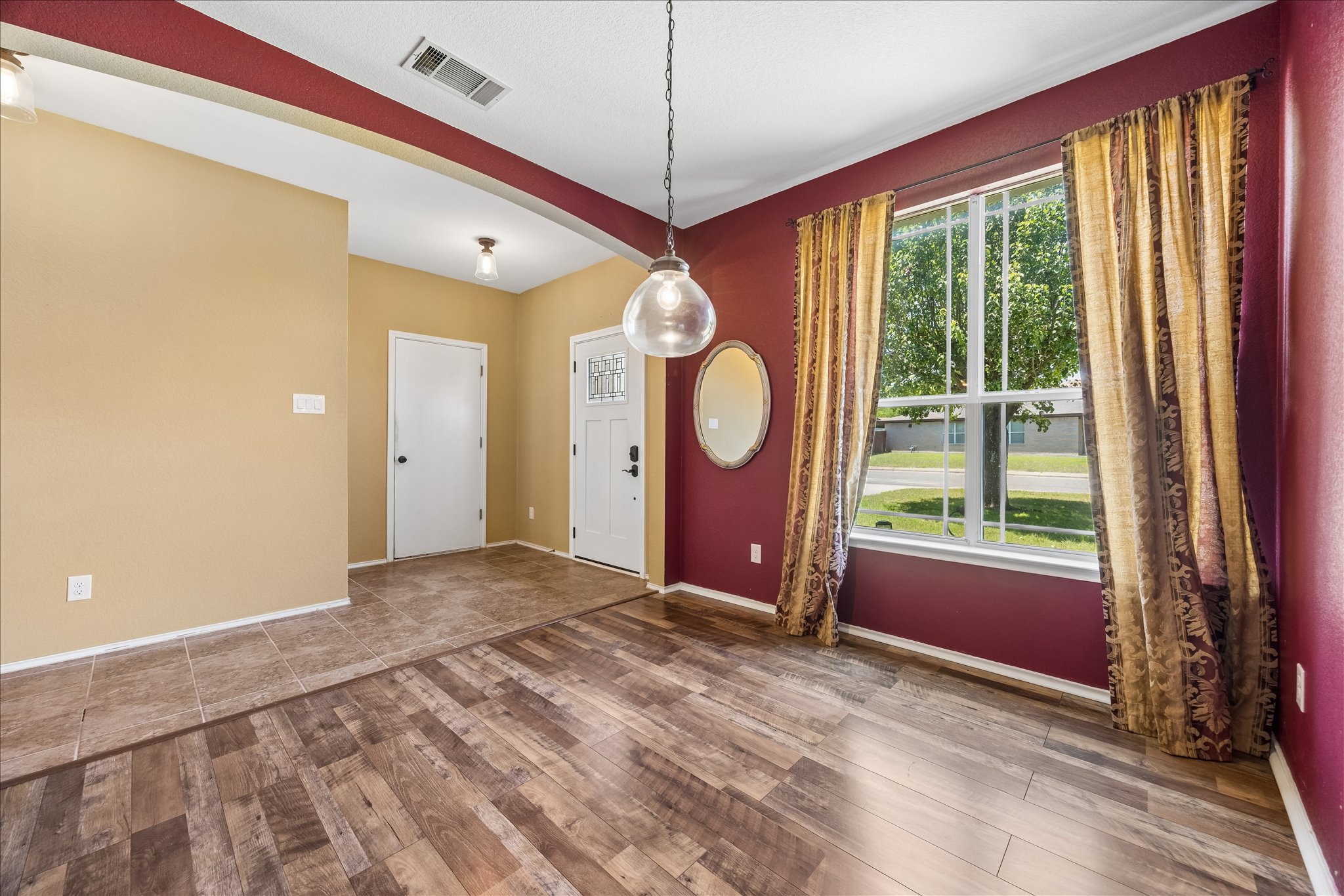 338 Spring Branch Loop Kyle, TX 78640 - Photo 5 of 36 Natural light illuminates rich flooring textures, defining this inviting entryway.
