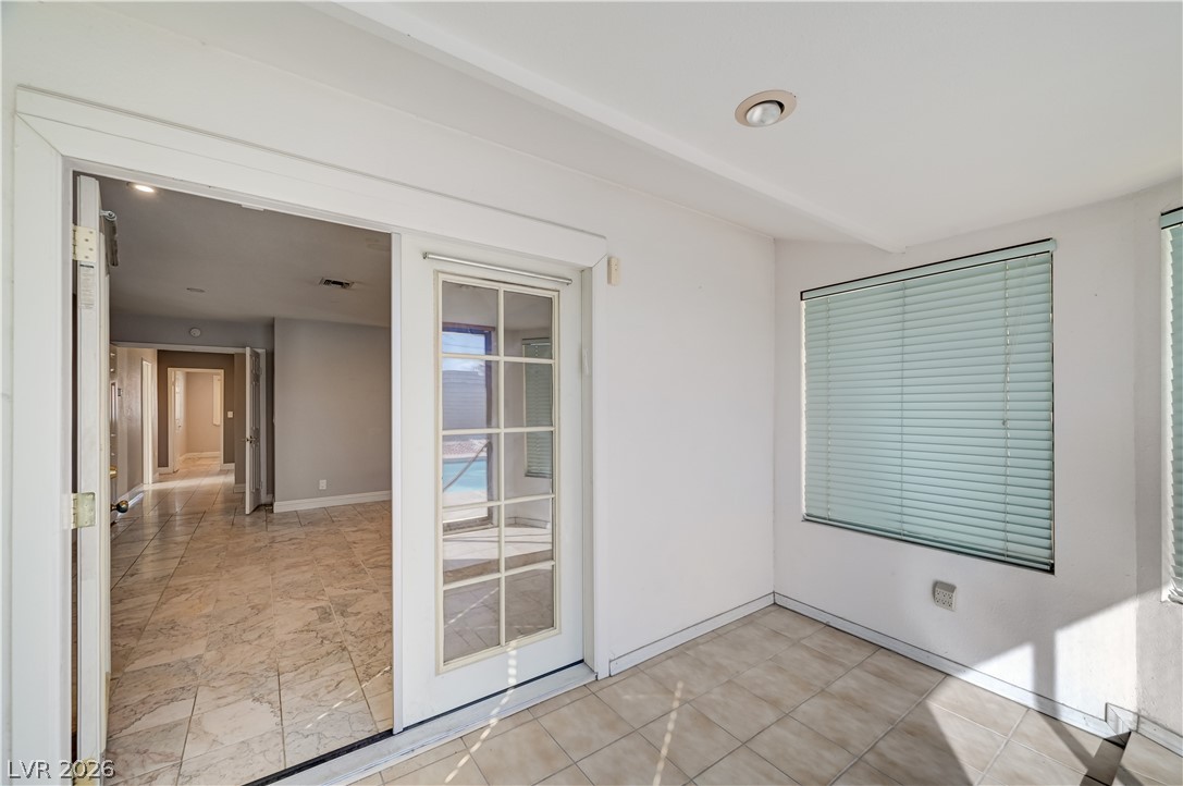 6635 Costa Brava Road Las Vegas, NV 89146 - Photo 35 of 59 A tiled room opens to an inner hallway and a sunny outdoor pool area.