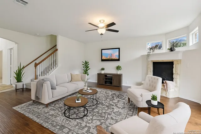 a living room with furniture a fireplace and a flat screen tv