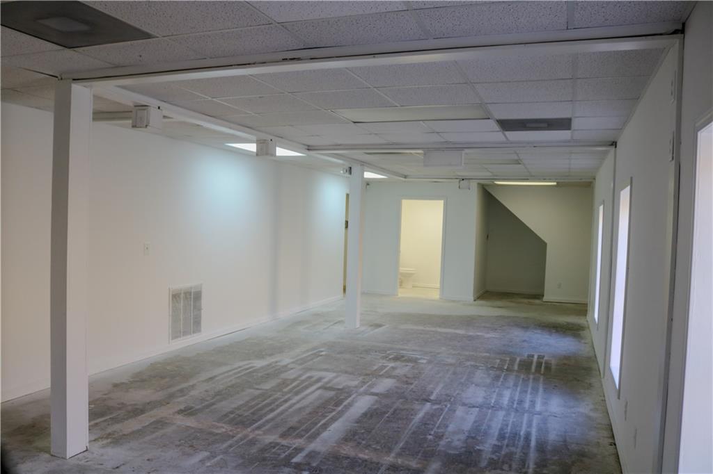 6519 Spring Street Douglasville, GA 30134 - Photo 3 of 17 a view of an empty room with wooden floor and a window