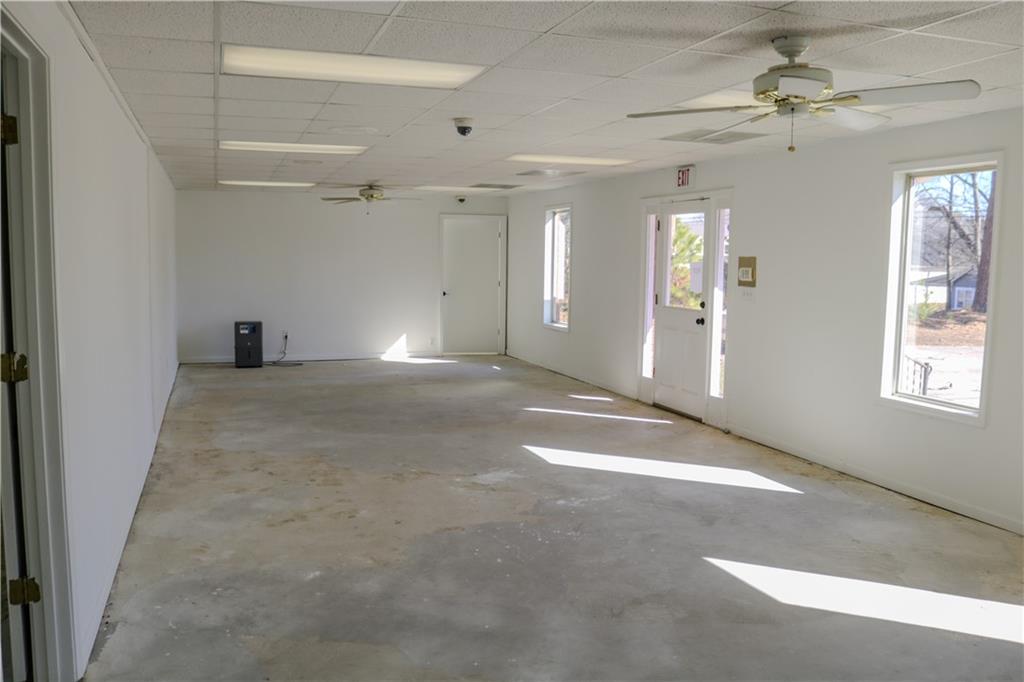 6519 Spring Street Douglasville, GA 30134 - Photo 5 of 17 en empty room with windows and ceiling fan