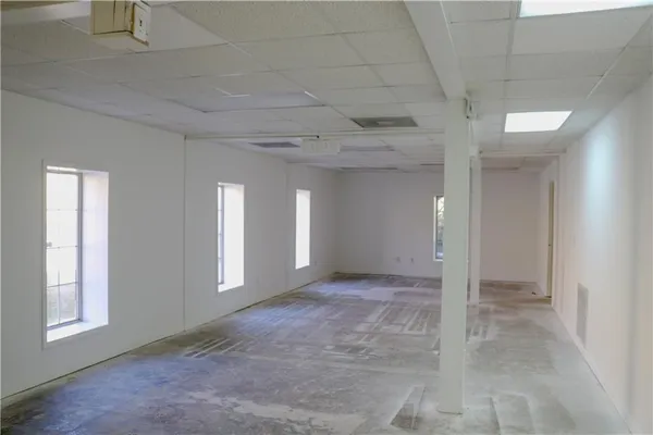 a view of a hallway with wooden floor and a window