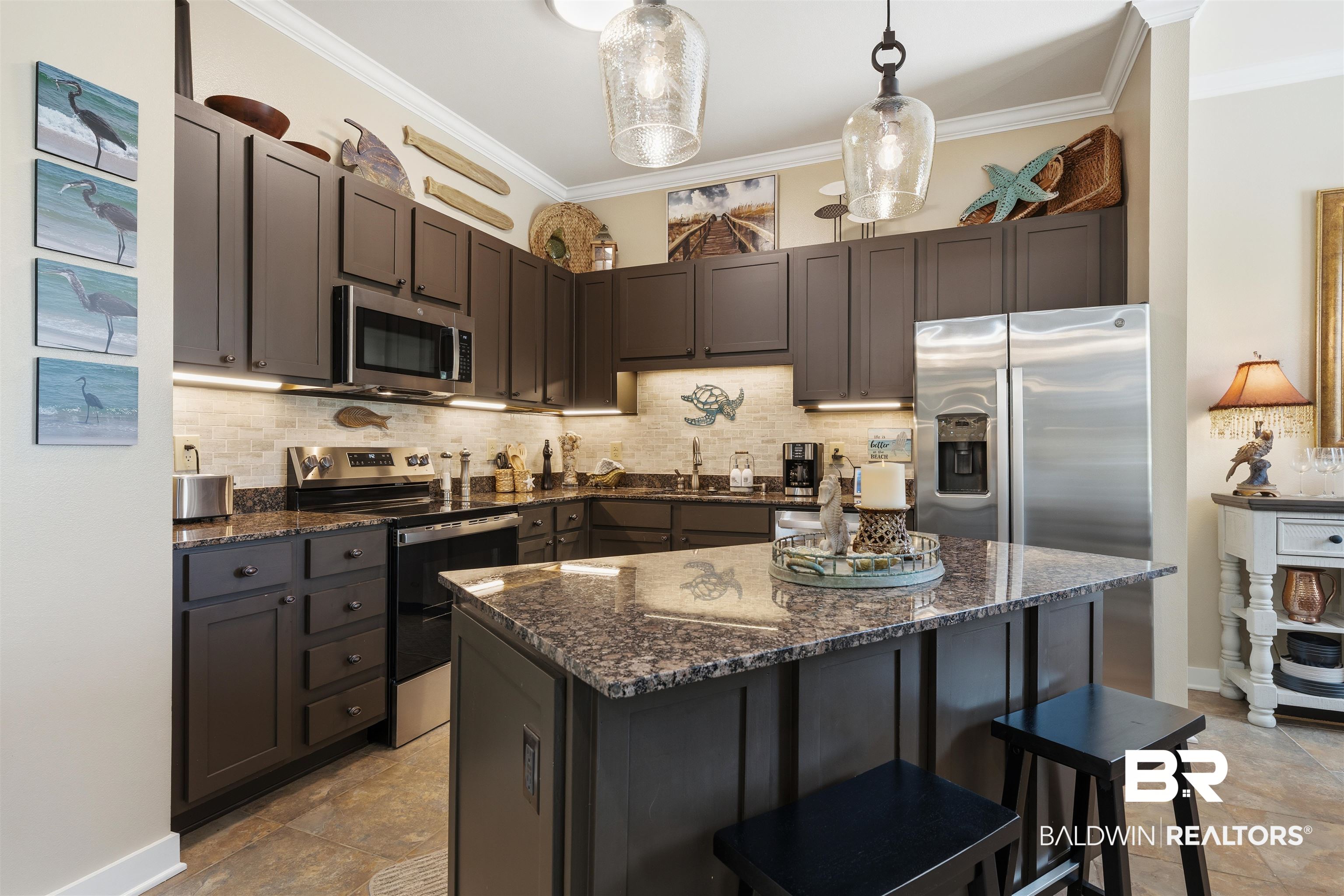 1430 Regency Road, Unit H202 Gulf Shores, AL 36542 - Photo 15 of 25 Kitchen featuring a kitchen breakfast bar, stainless steel appliances, dark stone countertops, decorative light fixtures, and tasteful backsplash