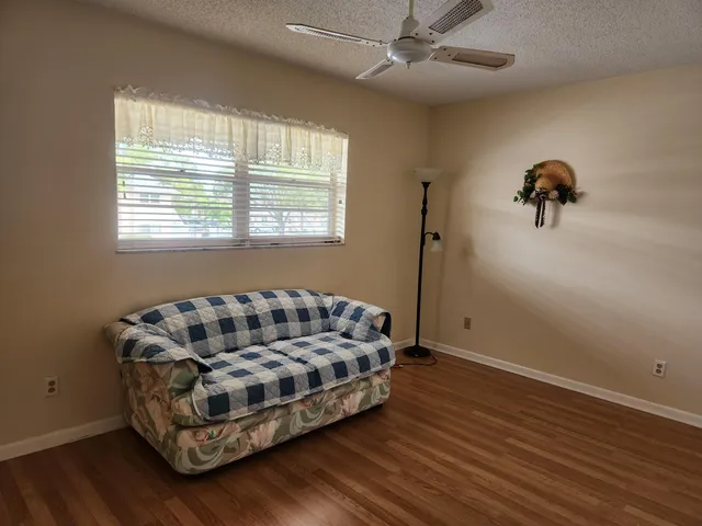a bedroom with bed couch and window