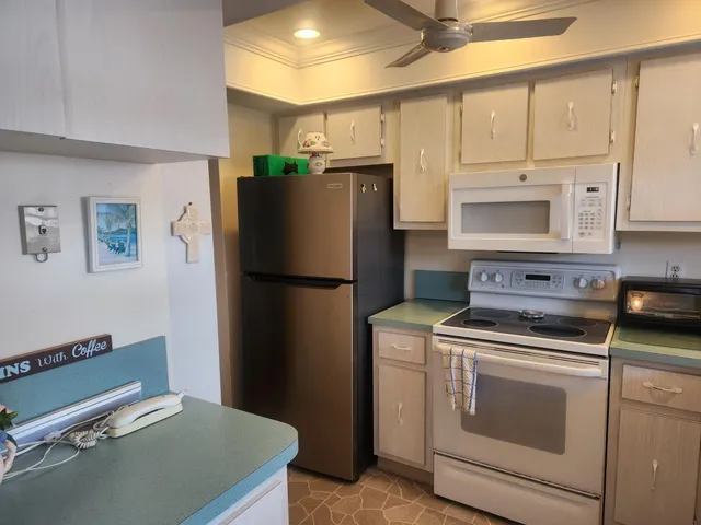 a kitchen with a stove cabinets and refrigerator