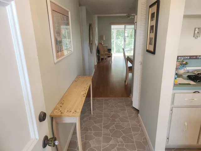 a view of hallway with stairs and wooden floor