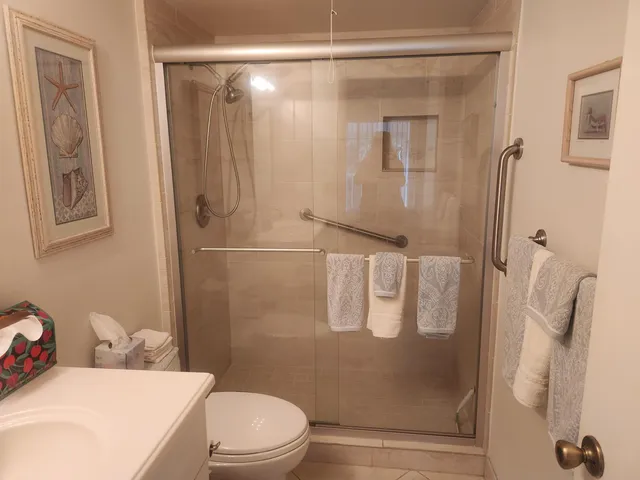 a bathroom with a shower toilet and sink
