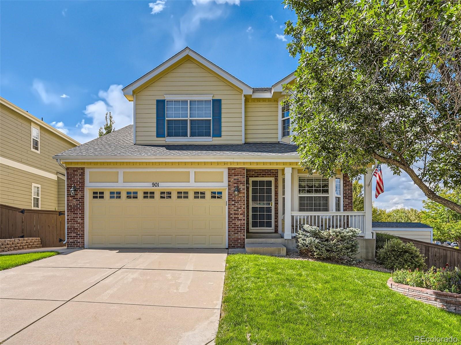 901 Riddlewood Road Highlands Ranch, CO 80129 - Photo 1 of 28 a front view of a house with a yard and garage