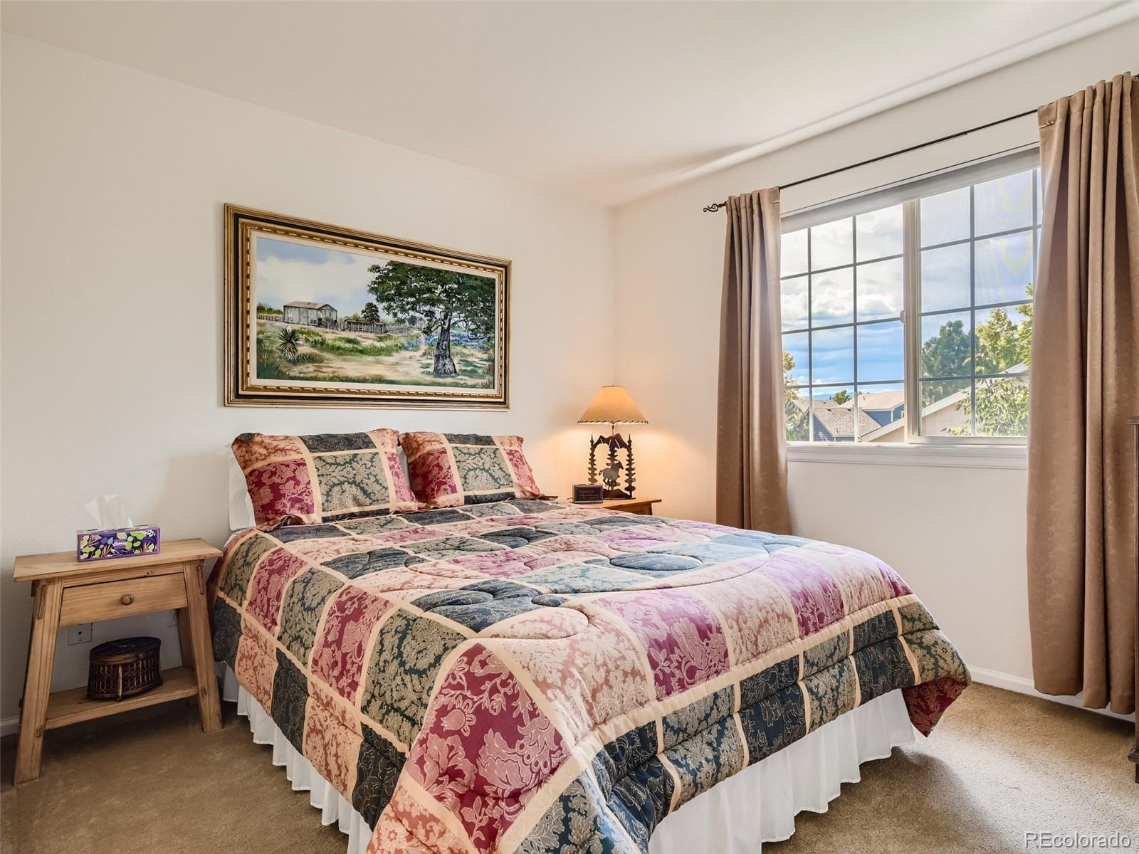 901 Riddlewood Road Highlands Ranch, CO 80129 - Photo 18 of 28 a bedroom with a bed and a window