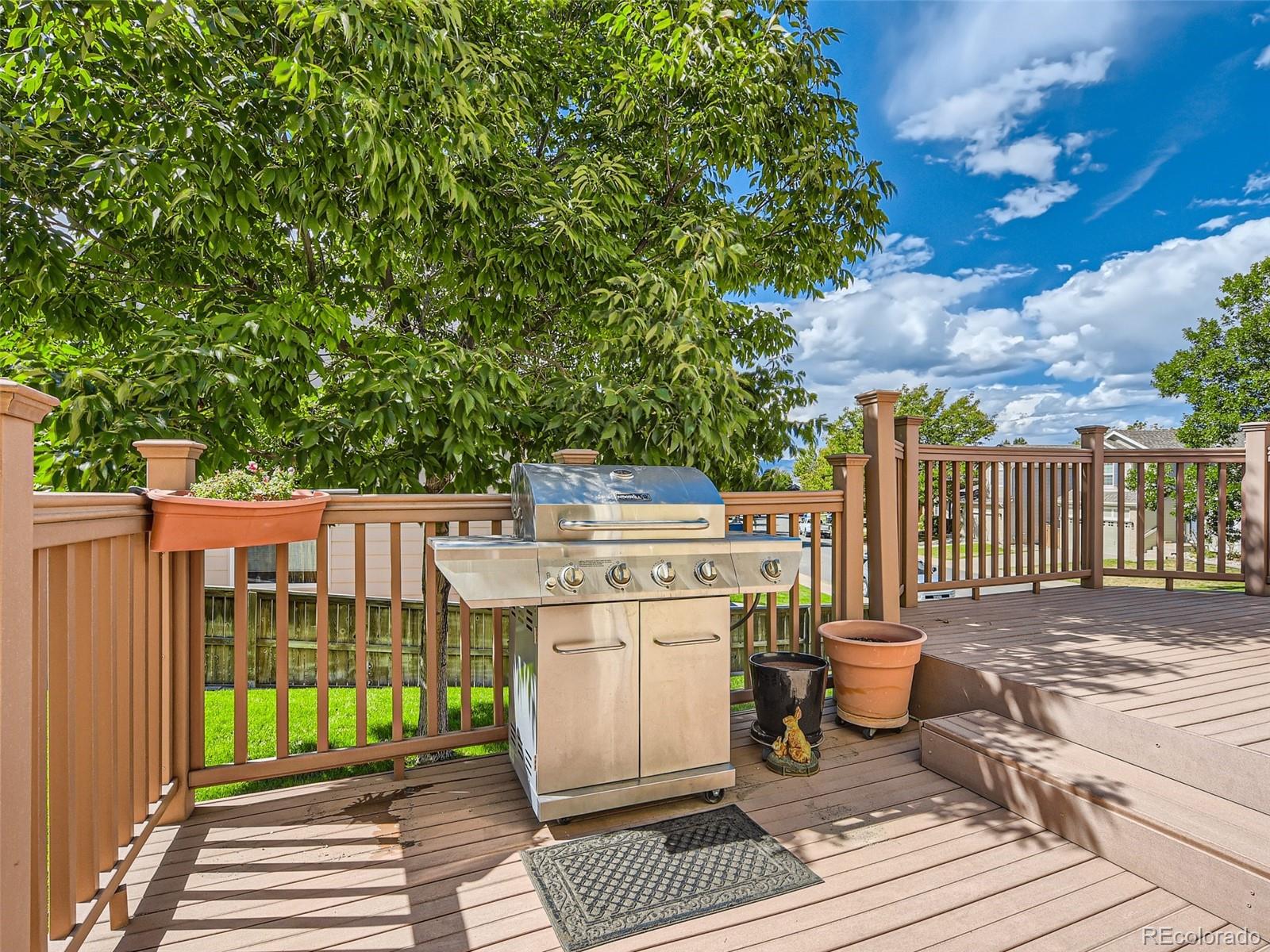 901 Riddlewood Road Highlands Ranch, CO 80129 - Photo 24 of 28 a view of a deck with wooden floor and fence