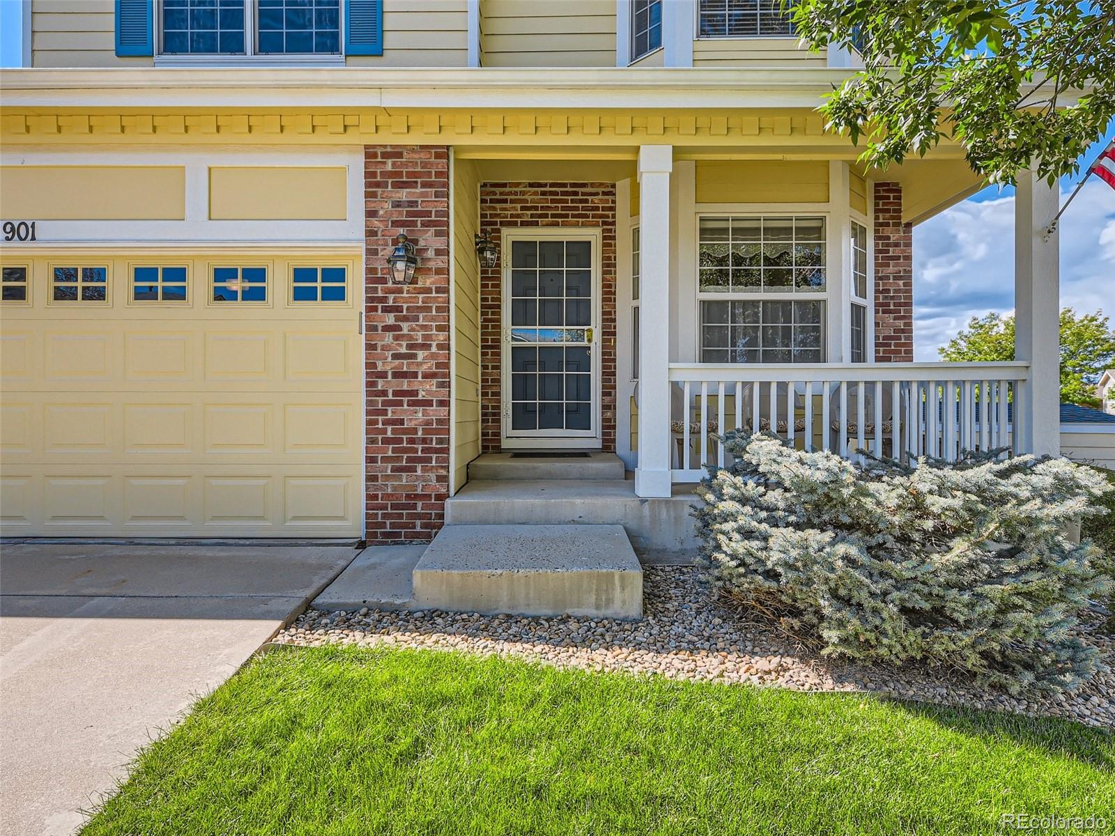 901 Riddlewood Road Highlands Ranch, CO 80129 - Photo 3 of 28 a front view of a house with a yard