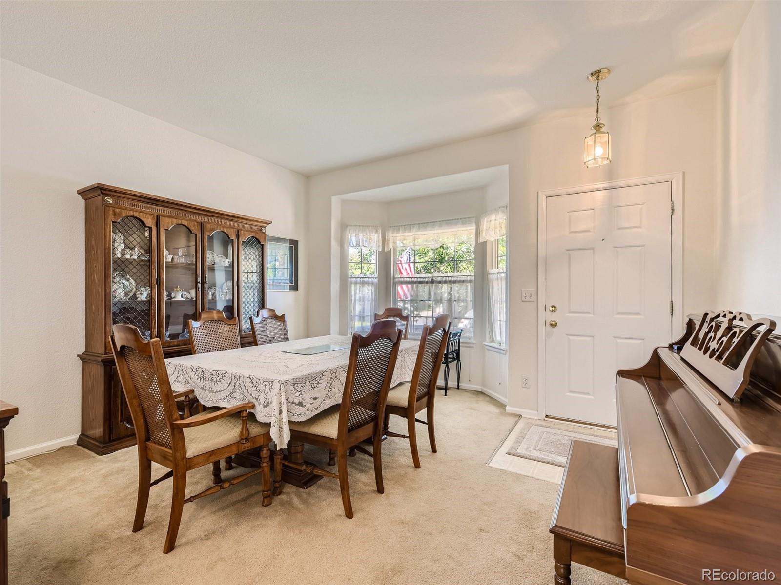 901 Riddlewood Road Highlands Ranch, CO 80129 - Photo 4 of 28 a view of a dining room with furniture window and outside view