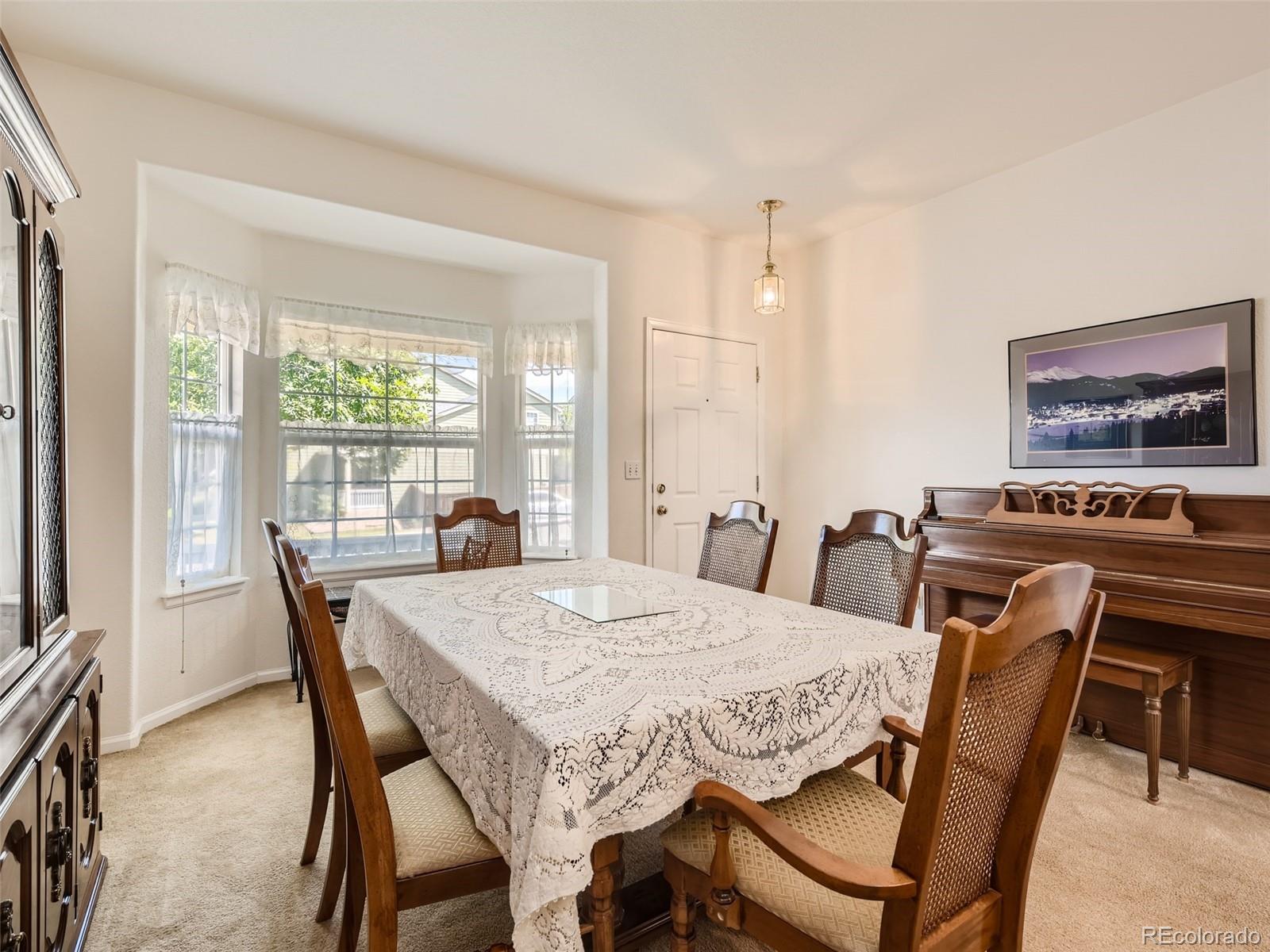901 Riddlewood Road Highlands Ranch, CO 80129 - Photo 6 of 28 a view of a dining room with furniture window and outside view