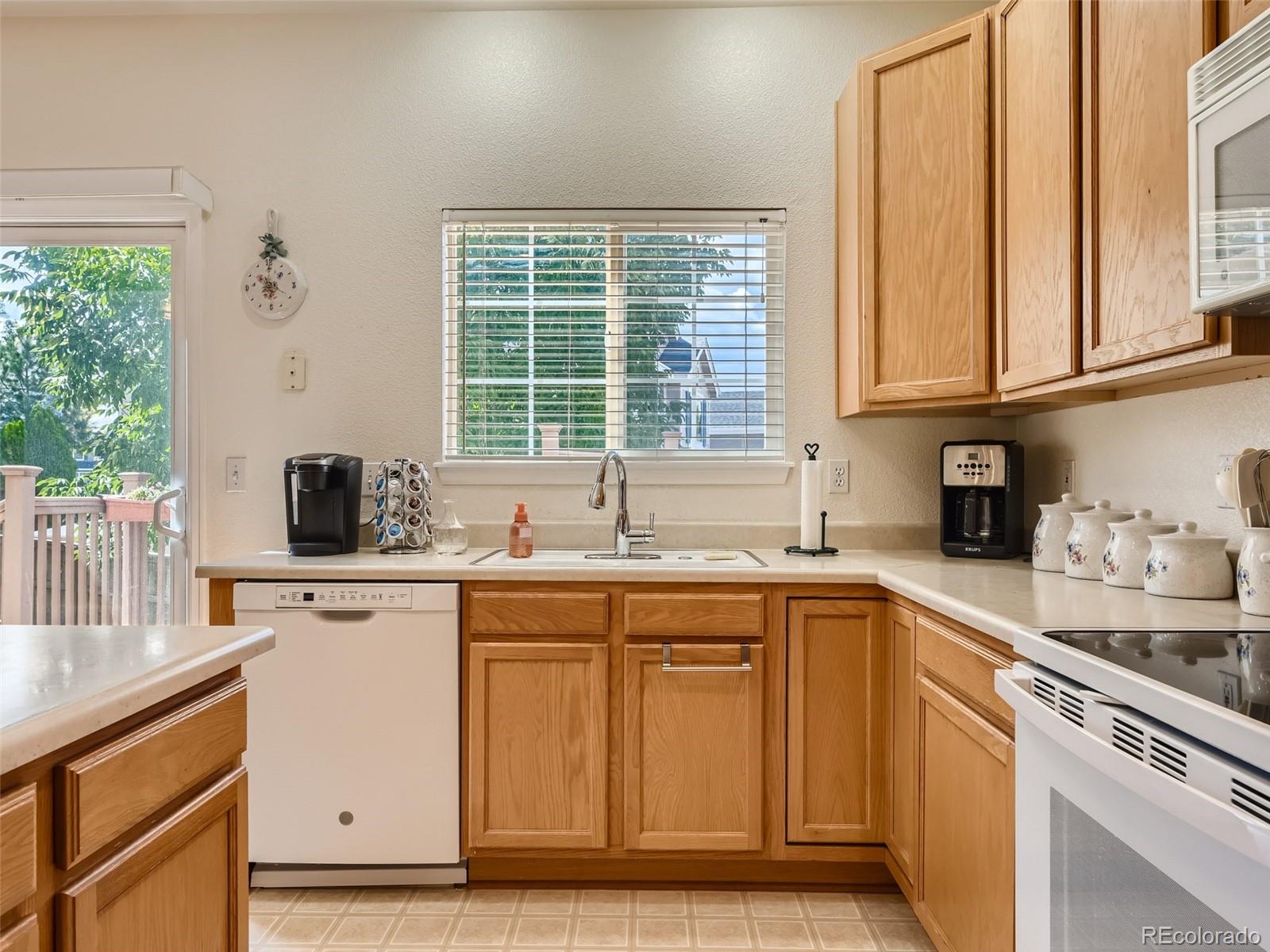 901 Riddlewood Road Highlands Ranch, CO 80129 - Photo 8 of 28 a kitchen with a sink stove and cabinets