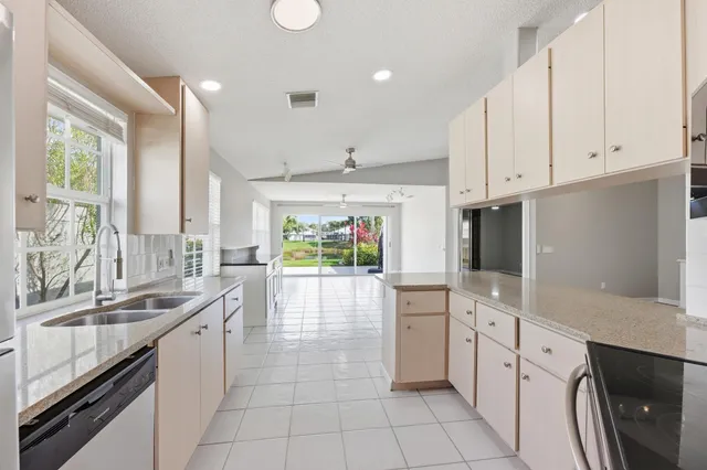 a kitchen with stainless steel appliances granite countertop a sink stove and cabinets