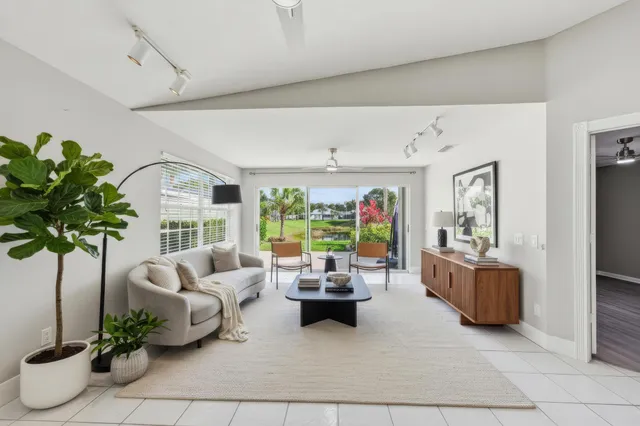 a living room with furniture and a potted plant
