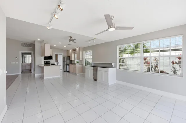 a view of a kitchen with furniture and a large window