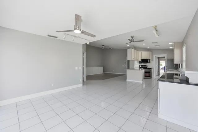 a view of a kitchen with a sink stainless steel appliances and cabinets