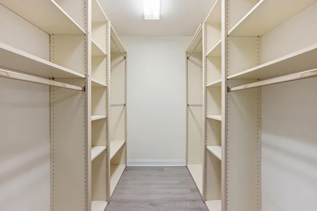 a view of hallway with wooden floor and staircase