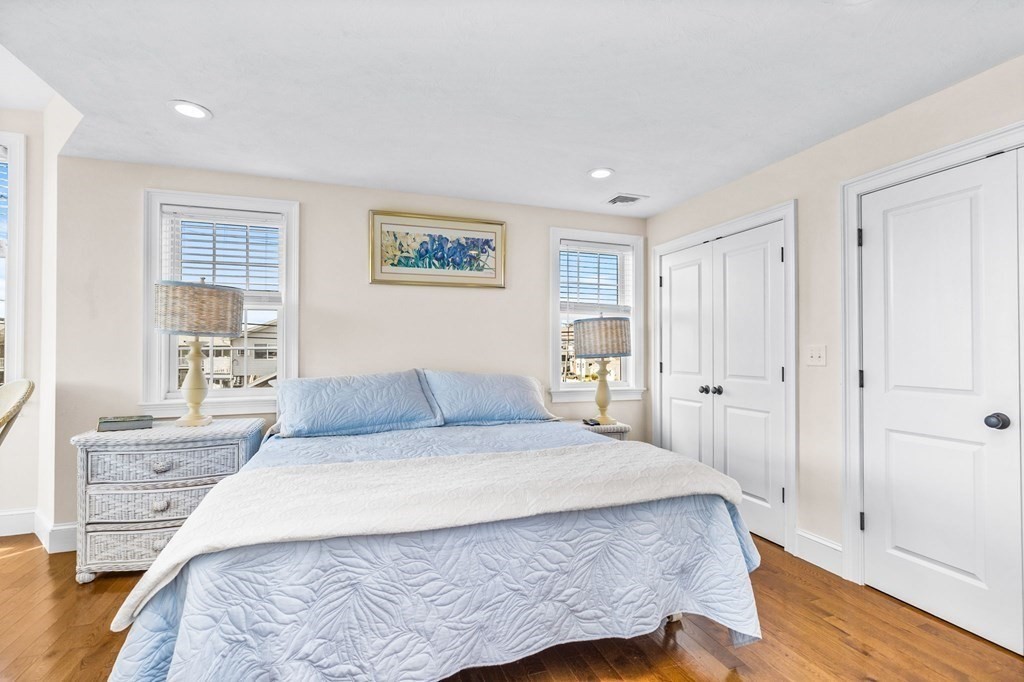 2 Chase Avenue Dennis, MA 02639 - Photo 15 of 24 a bedroom with a large bed and wooden floor