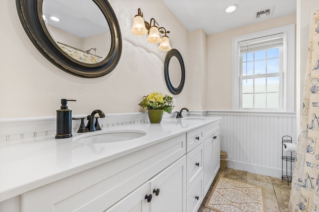 2 Chase Avenue Dennis, MA 02639 - Photo 19 of 24 a bathroom with a double vanity sink and a mirror