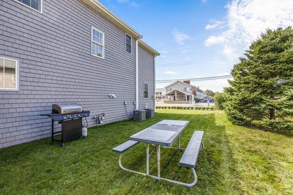 2 Chase Avenue Dennis, MA 02639 - Photo 5 of 24 a backyard of a house with table and chairs
