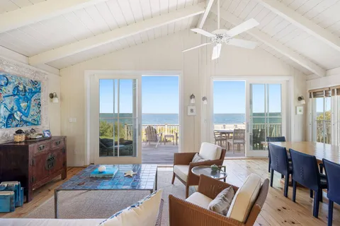 a living room with furniture and a floor to ceiling window