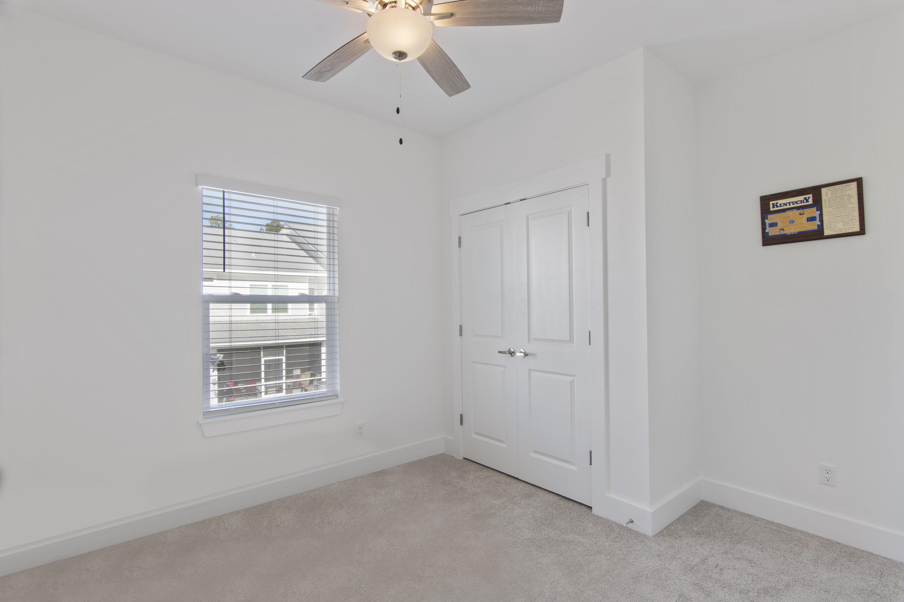 16 Date Palm Lane Freeport, FL 32439 - Photo 16 of 35 an empty room with chandelier fan and windows