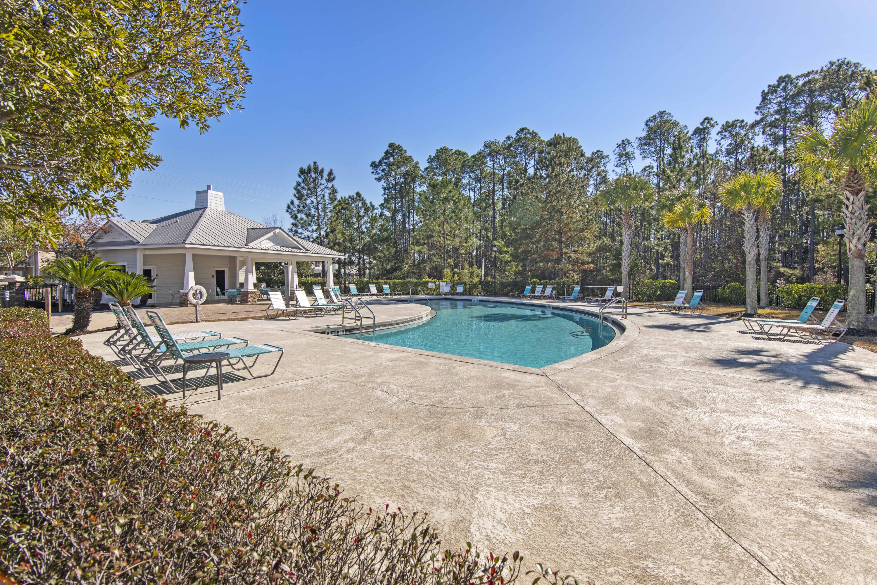 16 Date Palm Lane Freeport, FL 32439 - Photo 22 of 35 a view of swimming pool with outdoor seating and trees in the background
