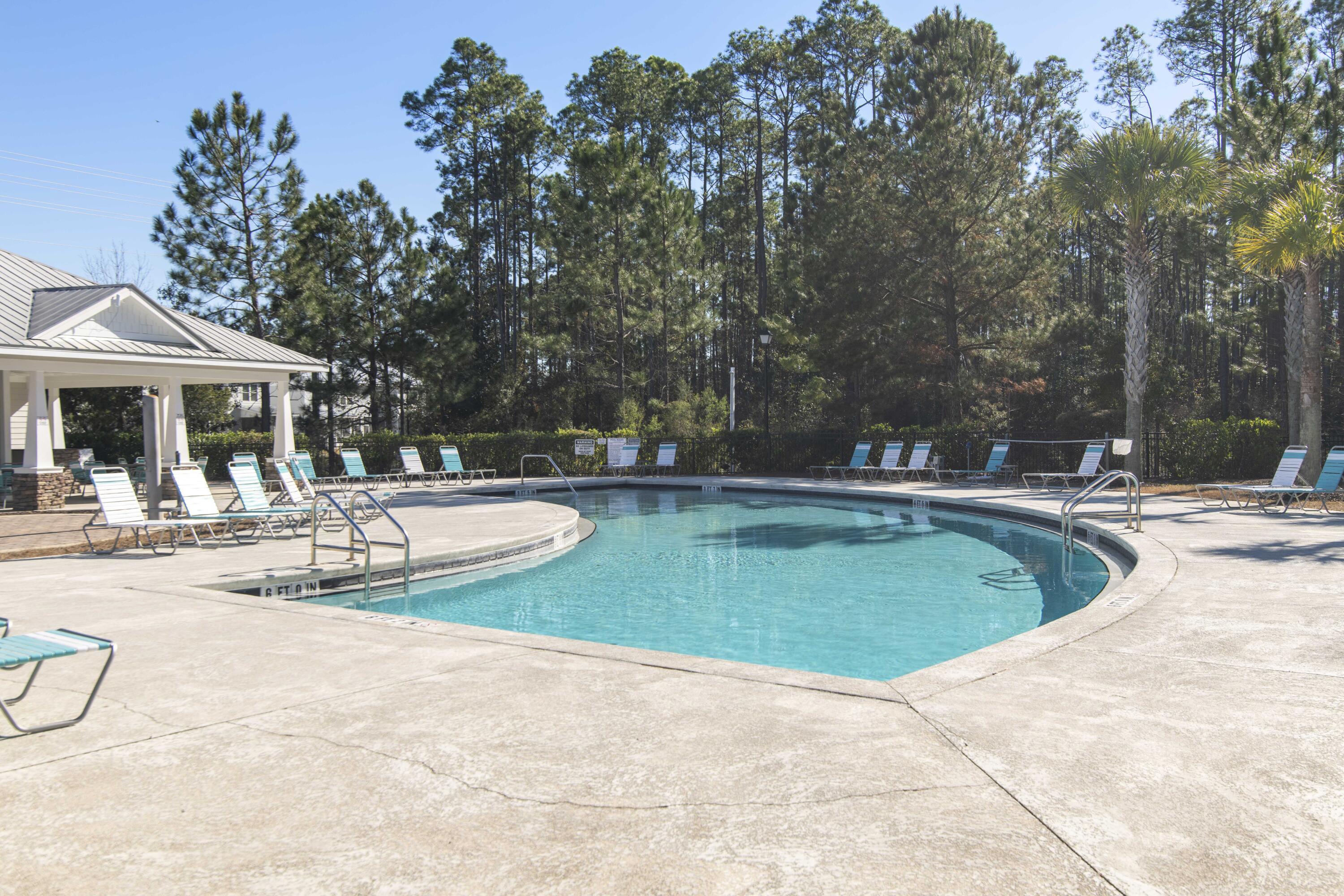 16 Date Palm Lane Freeport, FL 32439 - Photo 23 of 35 a view of a swimming pool and trees in the background